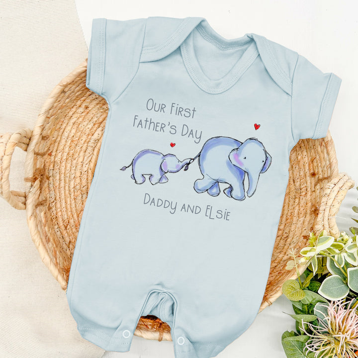 Personalised blue Father's Day romper that says 'Our first Father's Day Daddy and Elsie'. This design features 2 blue elephants