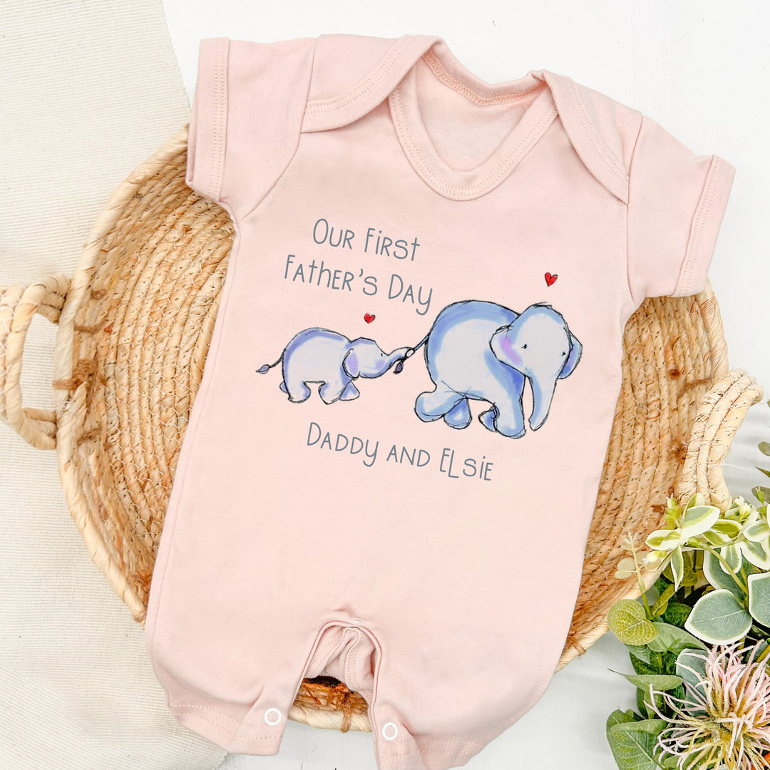 Personalised pink Father's Day romper that says 'Our first Father's Day Daddy and Elsie'. This design features 2 blue elephants