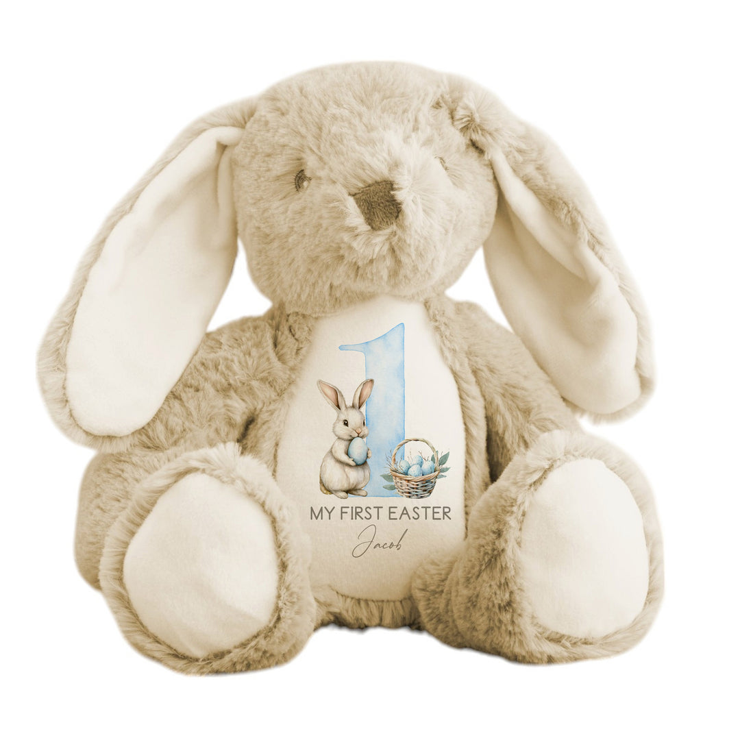 Personalised beige bunny Easter teddy that says 'My First Easter Jacob'. This design features a white bunny holding a blue Easter egg