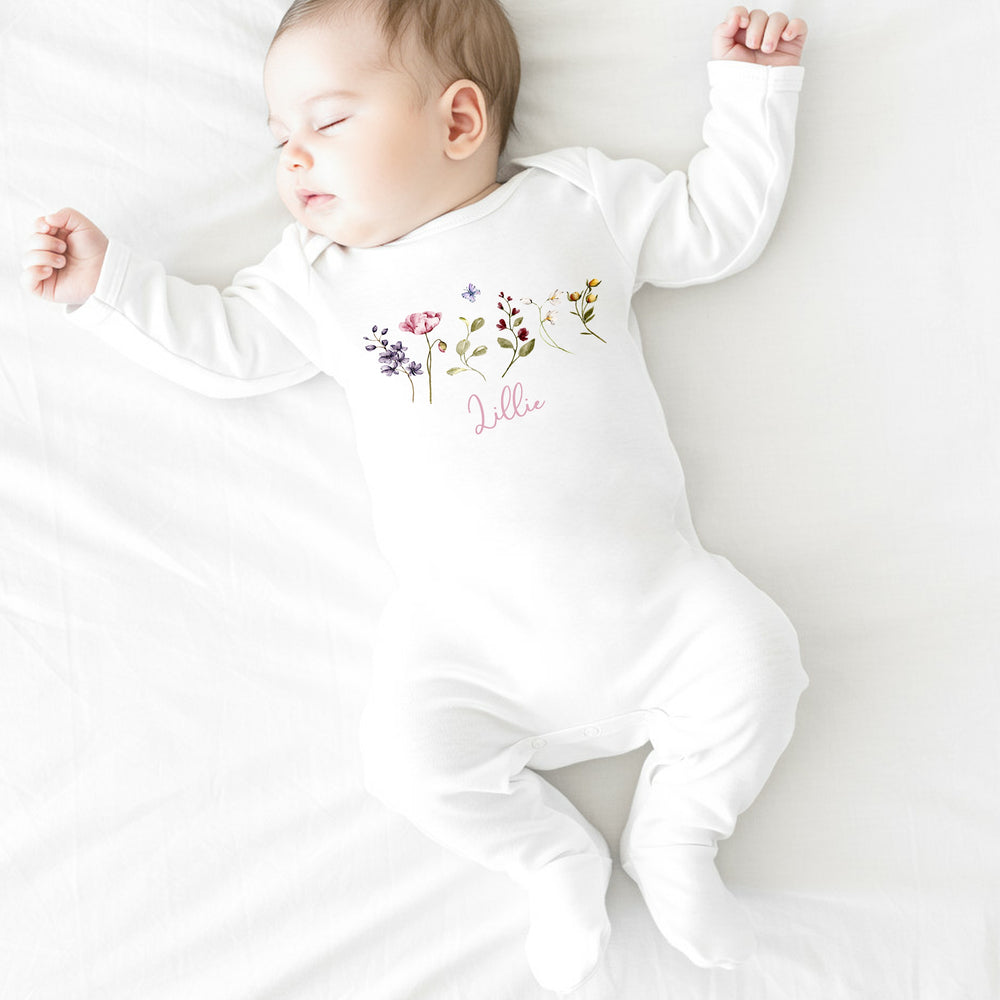 a personalised white baby grow that say 'Lillie' this design features lots of wild flowers