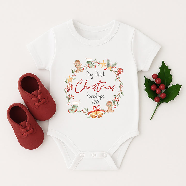 Baby t-shirt with 'My first Christmas' design and red shoes on a white background